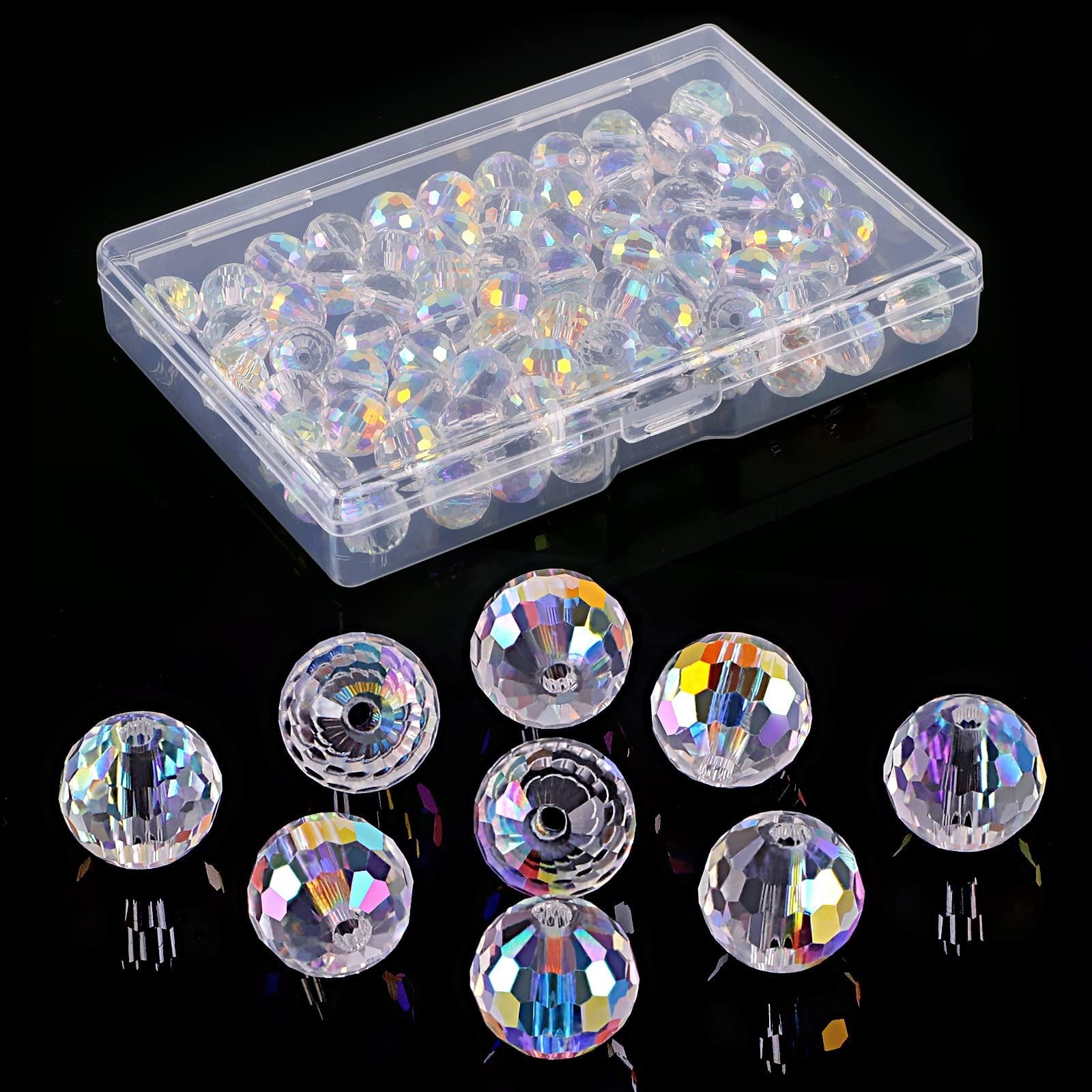Clear faceted glass beads in a plastic container and scattered on a black surface, showing iridescent rainbow highlights.