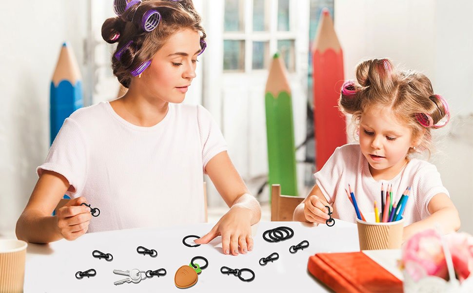 Woman and child with hair rollers crafting with black swivel snap hooks and key rings on a table
