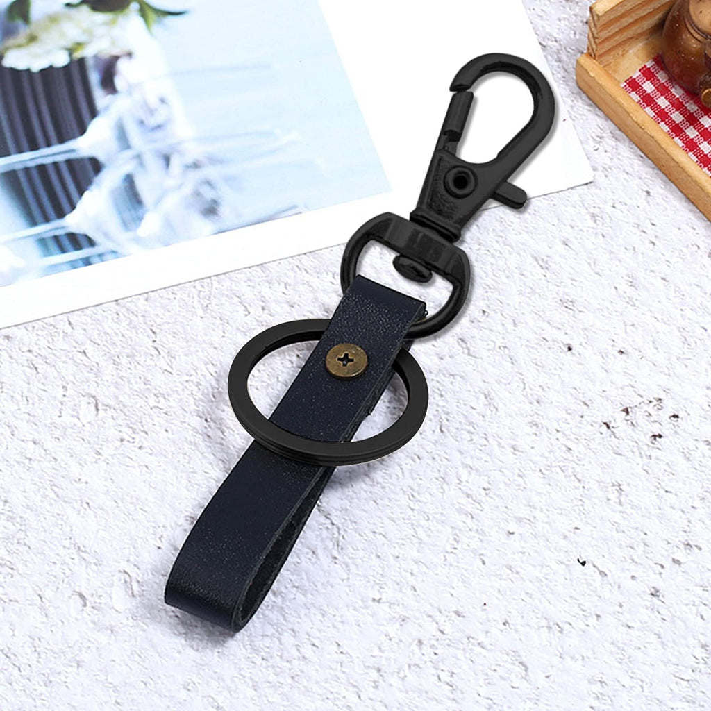 Black swivel snap hook with a dark blue leather strap and a black key ring attached, shown from a slightly elevated angle.