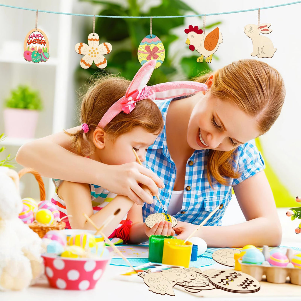 Mother and child painting unfinished wooden Easter ornaments, hanging on a string