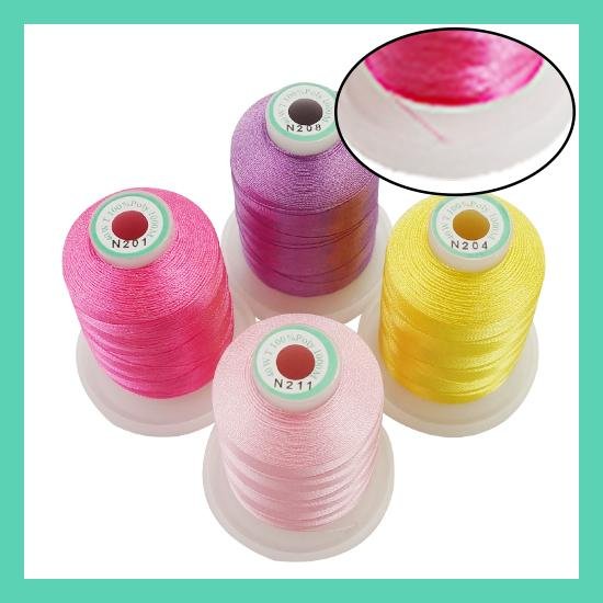 Four spools of colorful embroidery thread in pink, light pink, purple, and yellow, with a close-up inset view of pink thread.