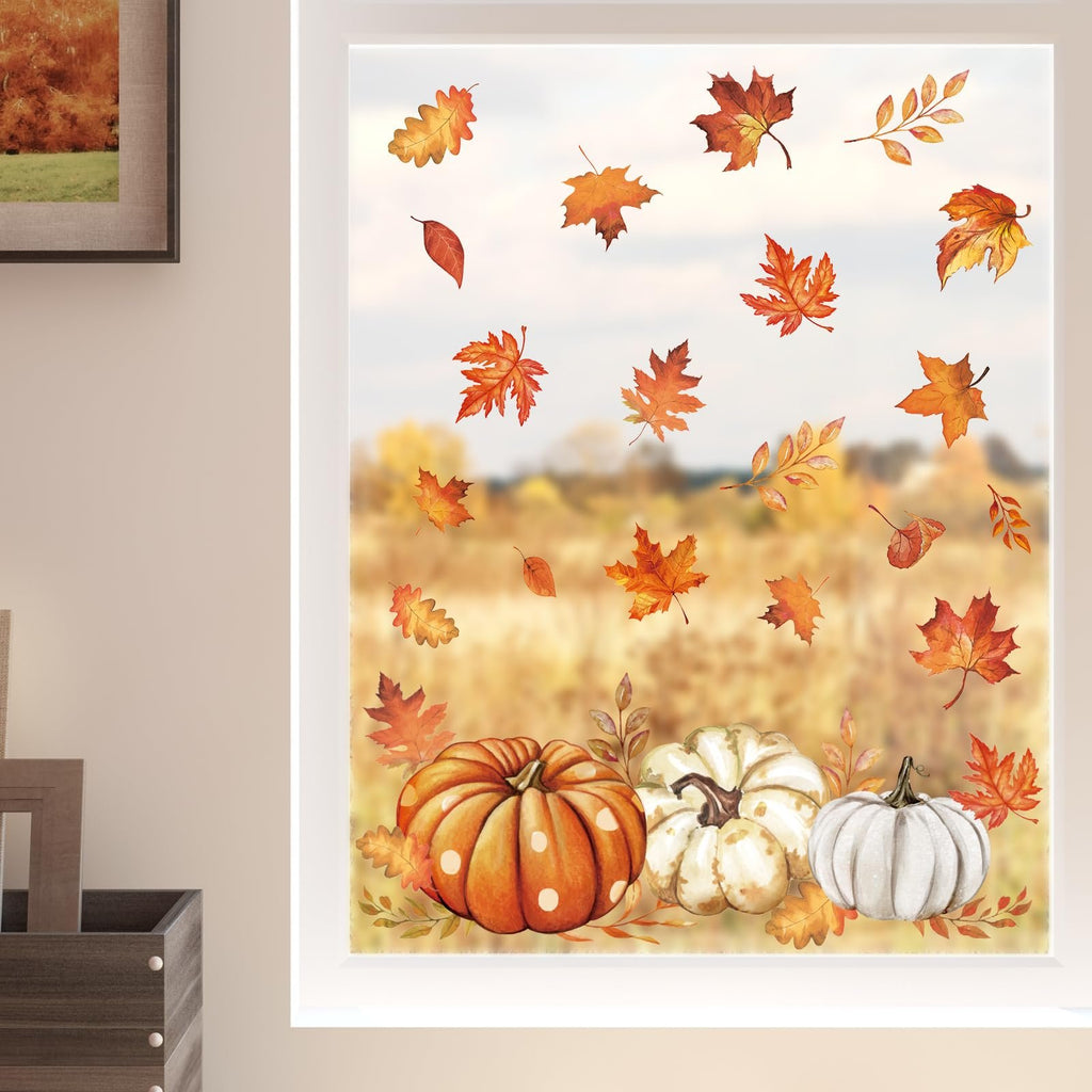 Autumn window clings featuring pumpkins and falling leaves, applied to a window with a blurred outdoor fall landscape.