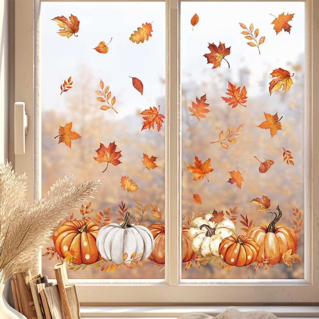 Autumn window clings featuring pumpkins and falling leaves applied to a window.