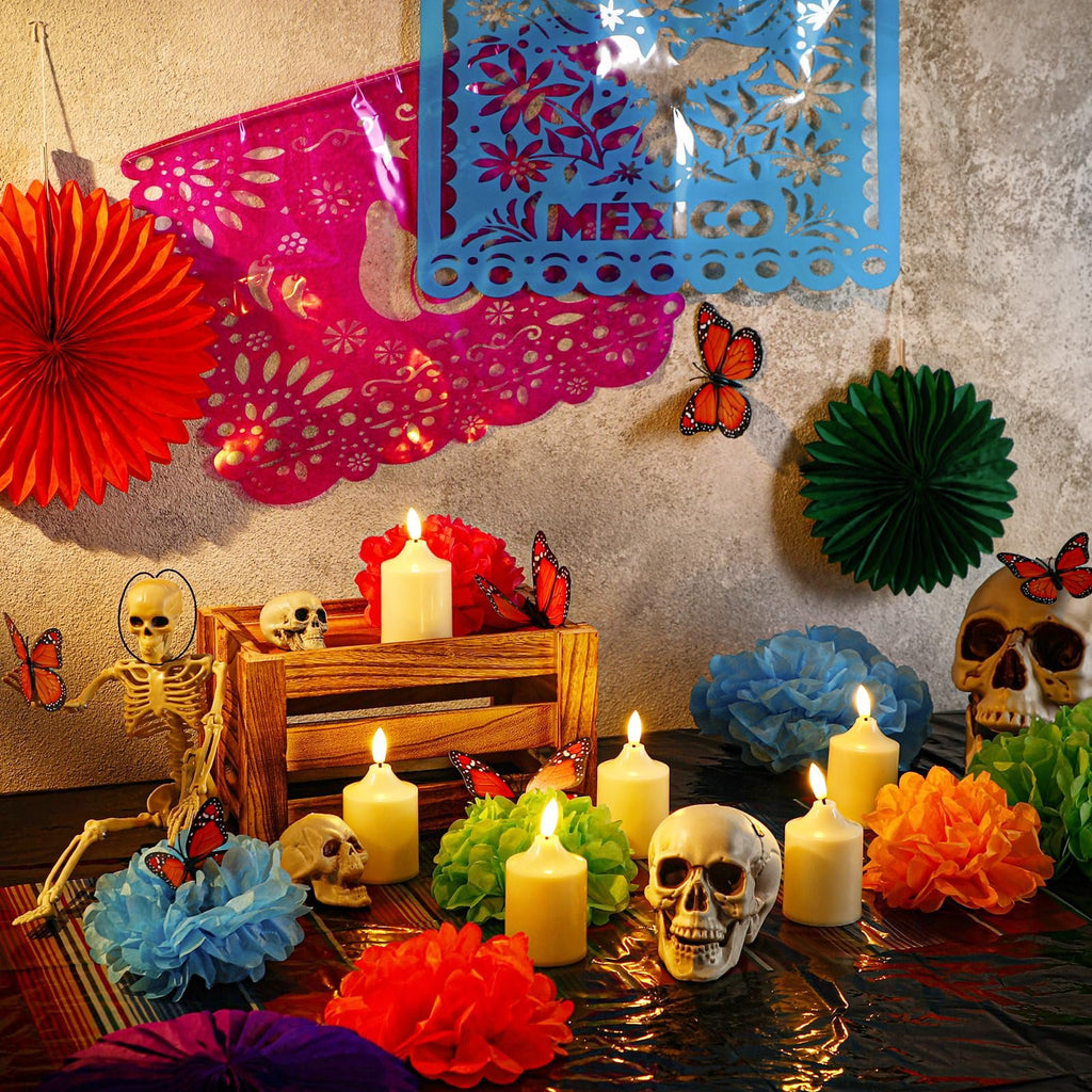 Day of the Dead altar setup with skeleton, skulls, LED candles, paper flowers, and decorative banners.