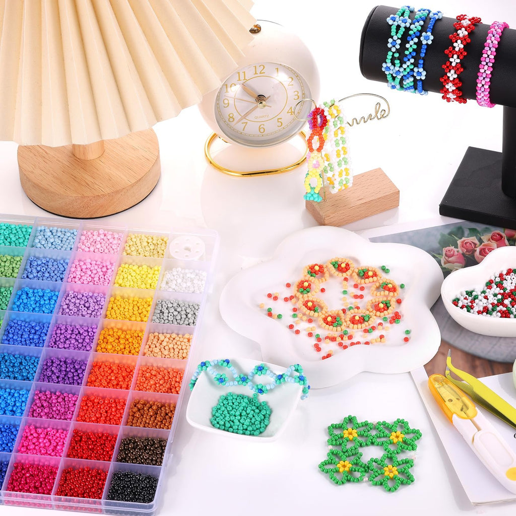 Plastic seed beads in a storage box with jewelry making supplies and finished beaded items.