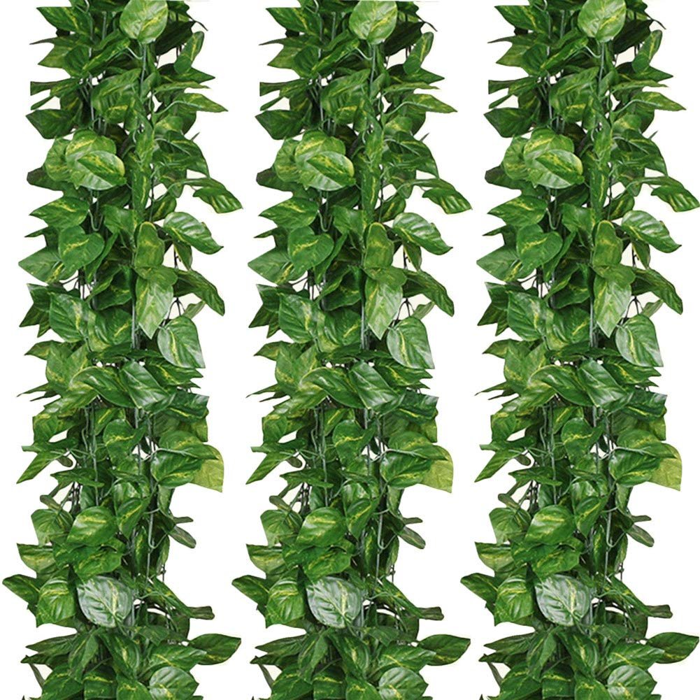 Three strands of artificial vine garland with green fabric leaves against a white background.