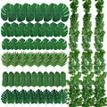 Assortment of artificial jungle vines and palm leaves on a white background, showing monstera leaves, palm fronds, and hanging vine strands.