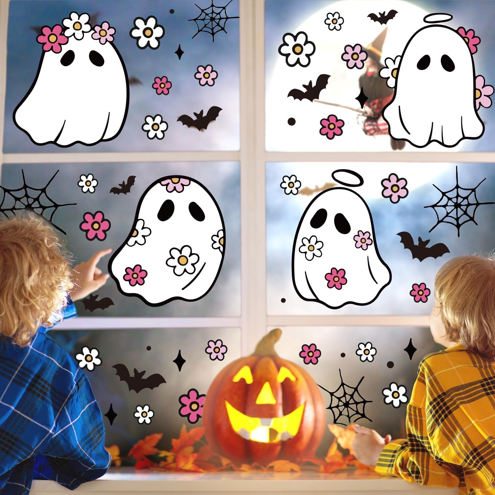 Children applying Halloween window clings featuring ghosts, bats, spiders, and flowers to a window.