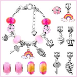 DIY charm bracelet making kit components including snake chains, pink beads, flower charms, rainbow charms, key charms, leaf charms, and crown charms.