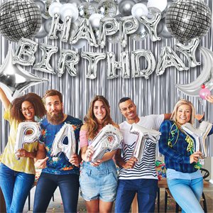 Group of five people holding silver balloons spelling PARTY, with HAPPY BIRTHDAY foil balloons and disco balls overhead.