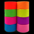 Stack of eight rolls of neon crepe paper streamers in red, green, pink, blue, orange, yellow, purple, and light pink.