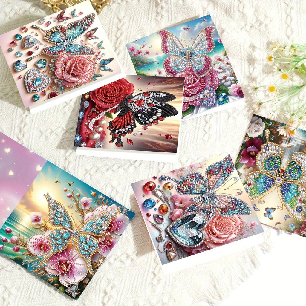 Collection of five diamond art greeting cards featuring butterflies and roses, adorned with colorful gems and beads.