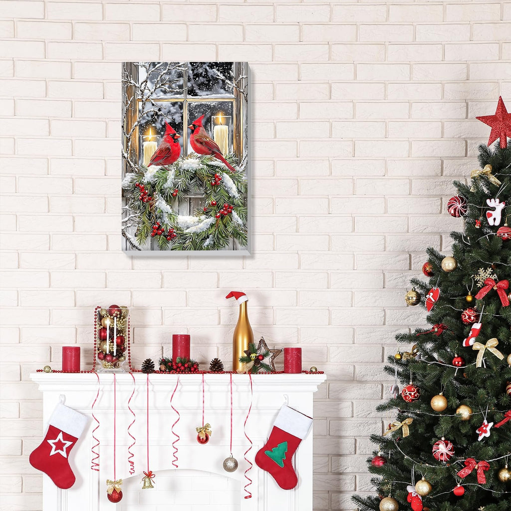 Framed winter scene painting of two cardinals on a snowy wreath in front of a window with lit candles, displayed above a decorated fireplace with a Christmas tree to the right.