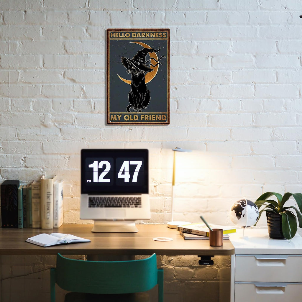 Black cat wearing a witch hat sits on a crescent moon with stars, on a metal tin sign that reads 'Hello Darkness My Old Friend'.