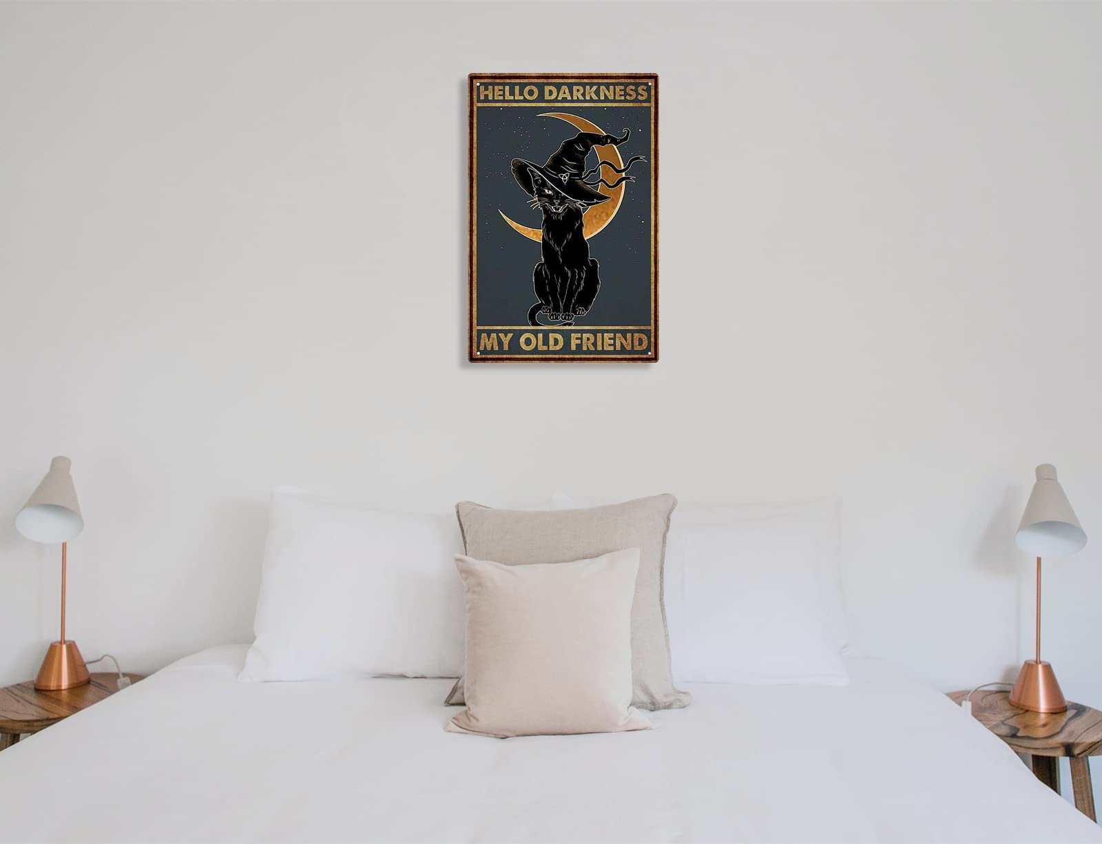 Black cat wearing a witch hat sits in front of a crescent moon on a tin sign that reads 'Hello Darkness My Old Friend'.