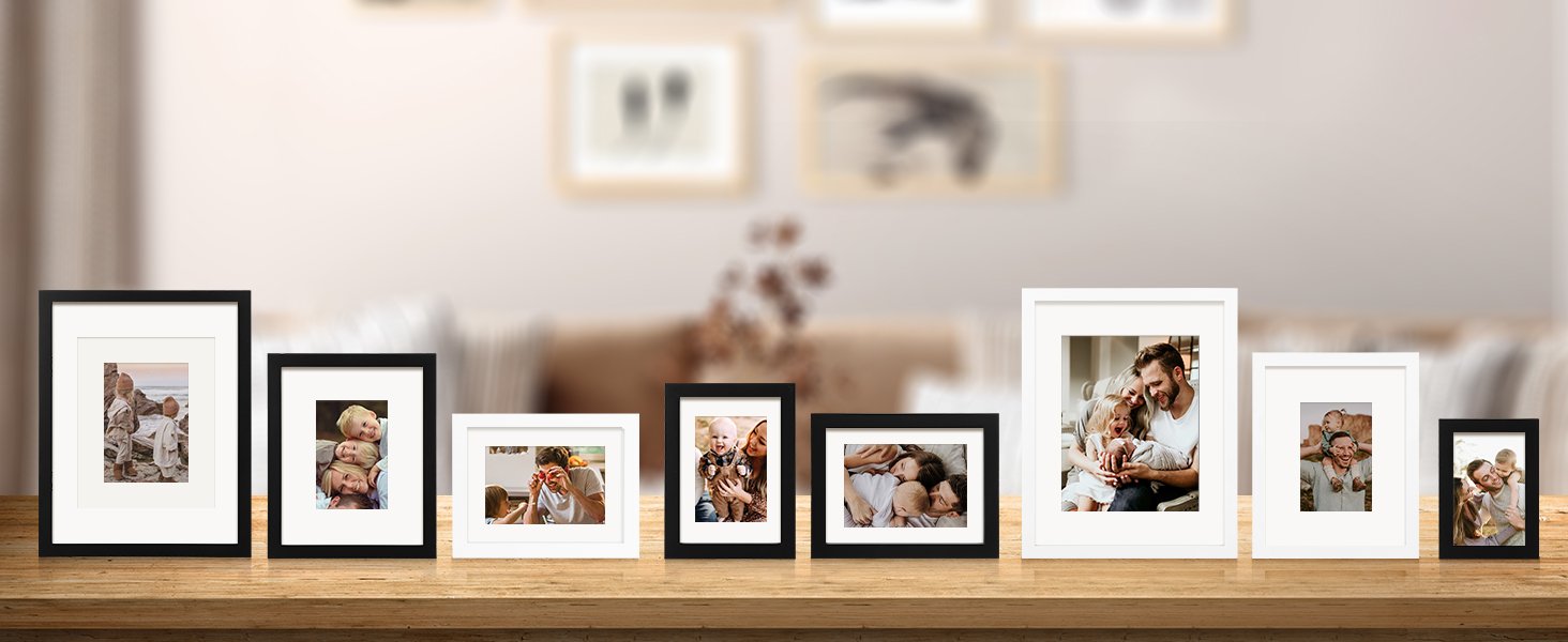 Collection of various sized picture frames displaying family photos on a wooden shelf