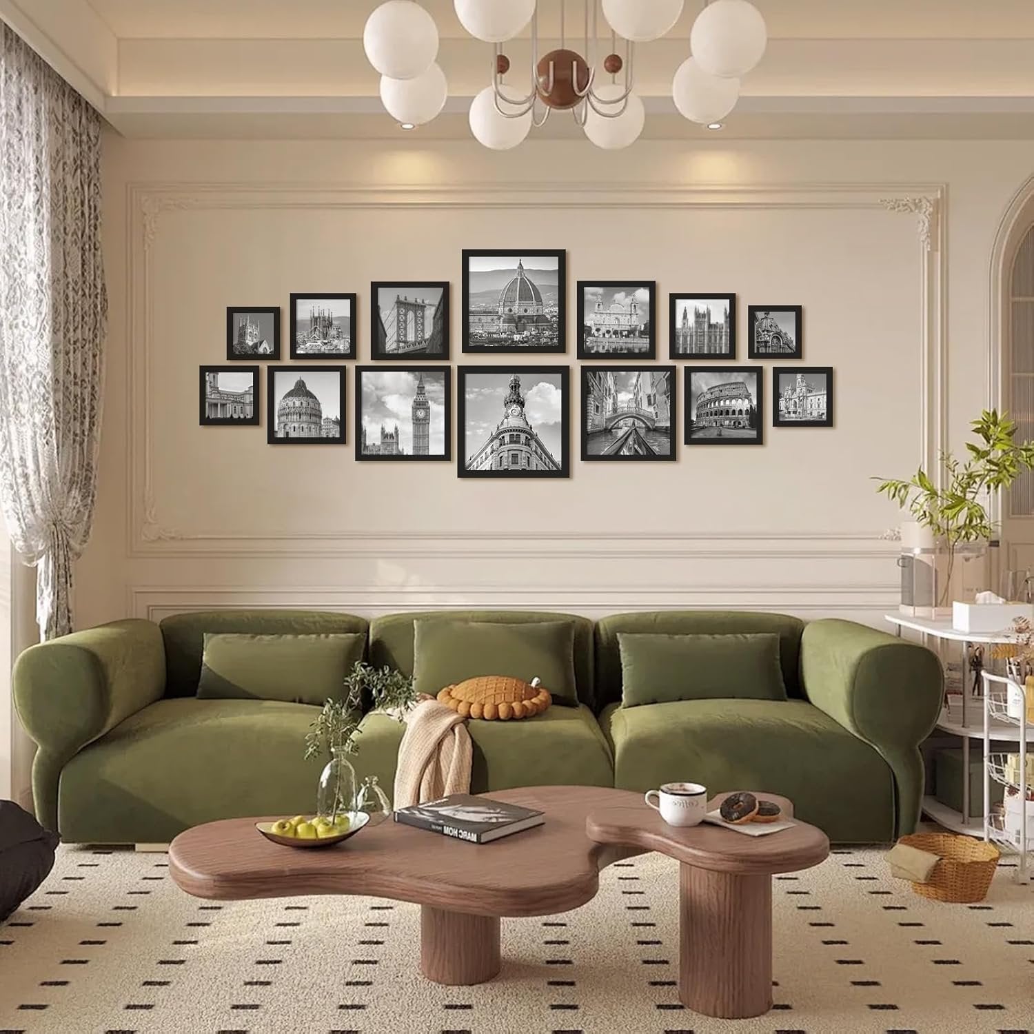 Gallery wall of black picture frames displaying European landmarks above a green sofa in a living room.