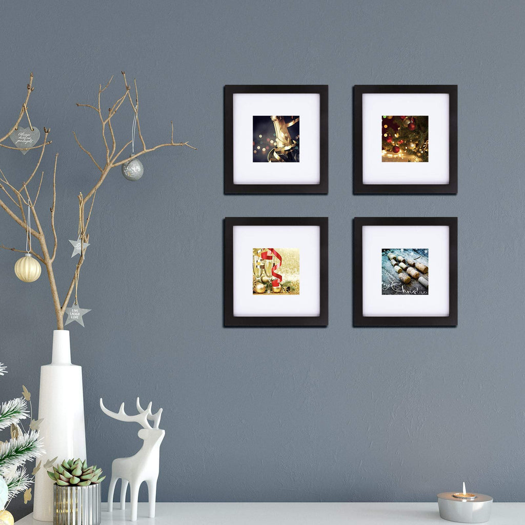 Four black 8x8 picture frames arranged on a wall, each displaying a festive holiday image.