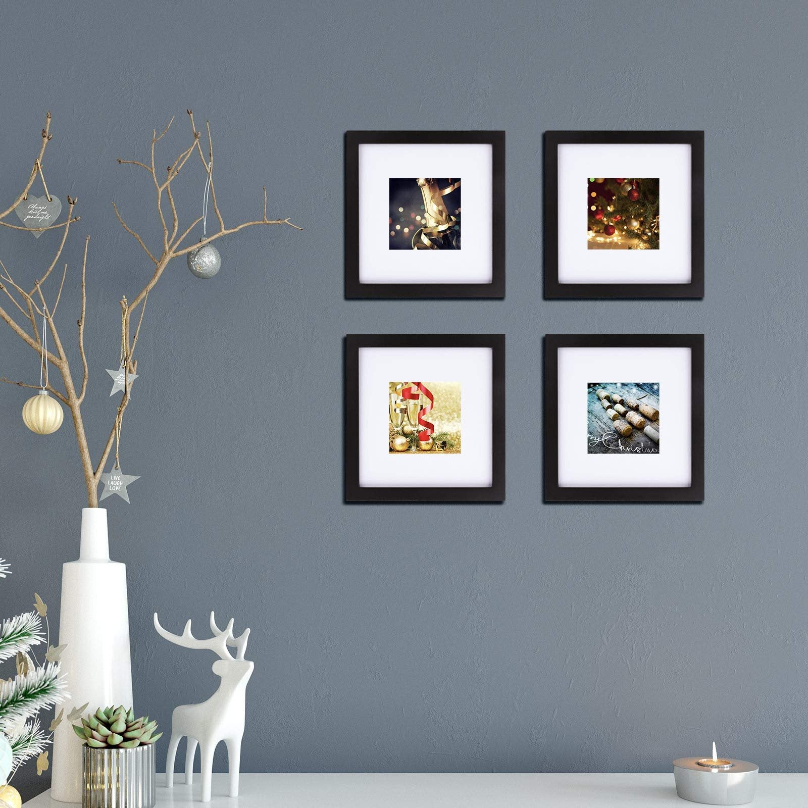 Four black 8x8 picture frames arranged on a wall, each displaying a festive holiday image.