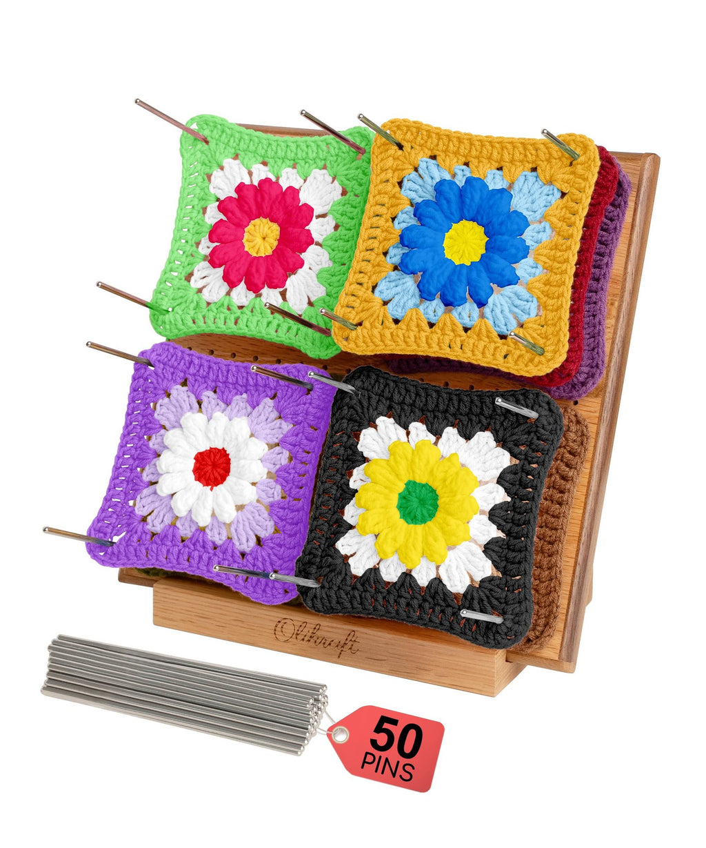 Wooden crochet blocking board with colorful granny squares pinned in place and a bundle of pins with a red tag.
