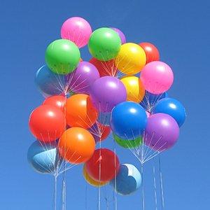 Cluster of 36-inch white latex balloons in various bright colors against a clear blue sky