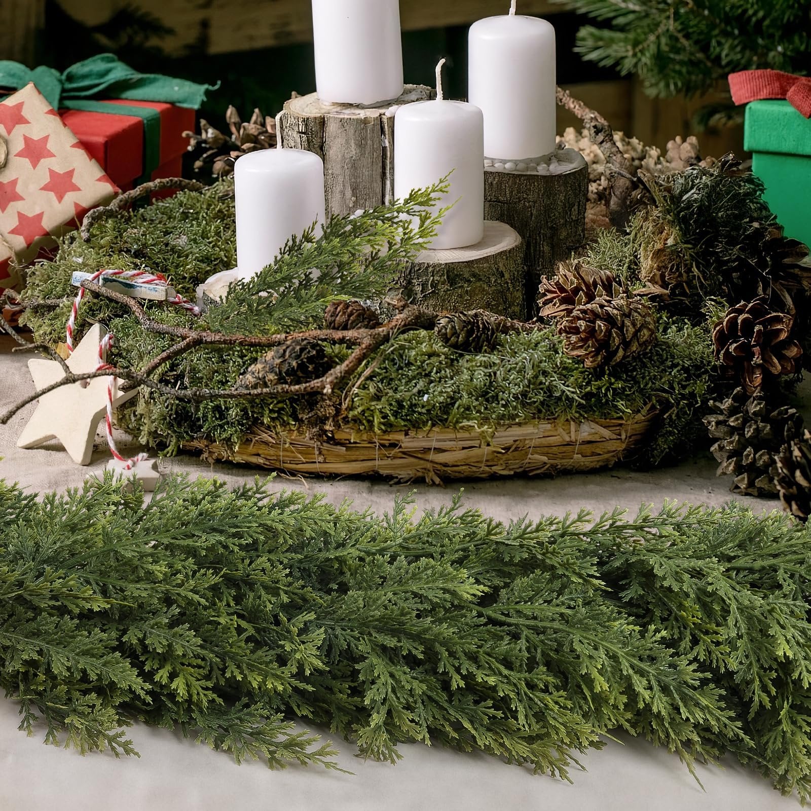 Artificial green cedar garland with pine cones and candles in a rustic Christmas arrangement