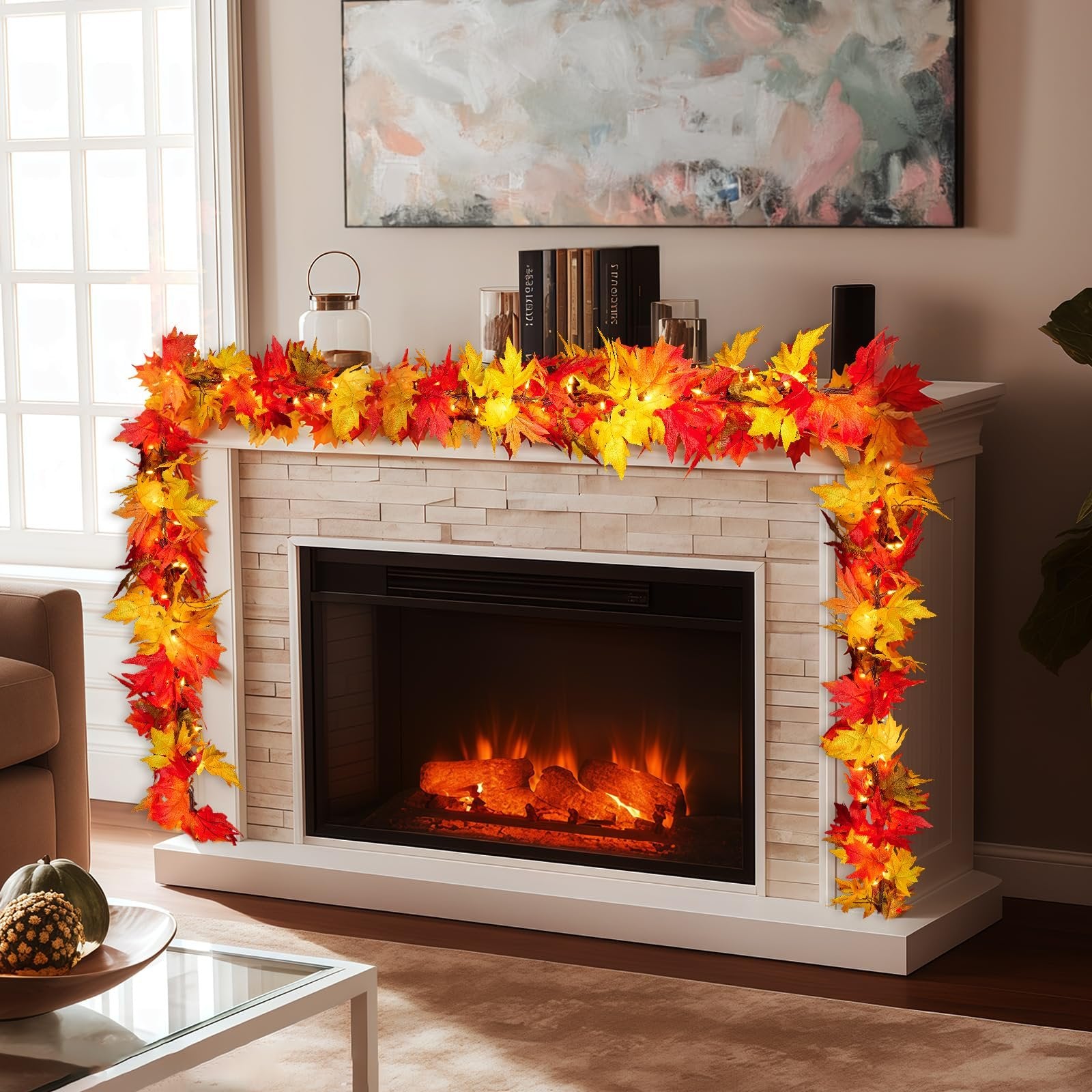 Fall maple leaf garland with warm orange lights draped over a fireplace mantel and down the side.