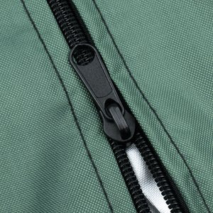 Close-up of a green Christmas tree storage bag zipper and textured fabric.