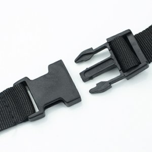 Close-up of black plastic buckle and strap on white background