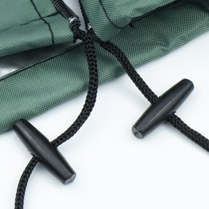 Close-up of green Christmas tree storage bag with black drawstring closures and toggles.