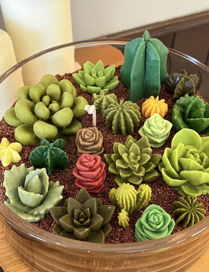 Assortment of 3D succulent and cactus shaped silicone molds arranged in a glass bowl with brown filler material.