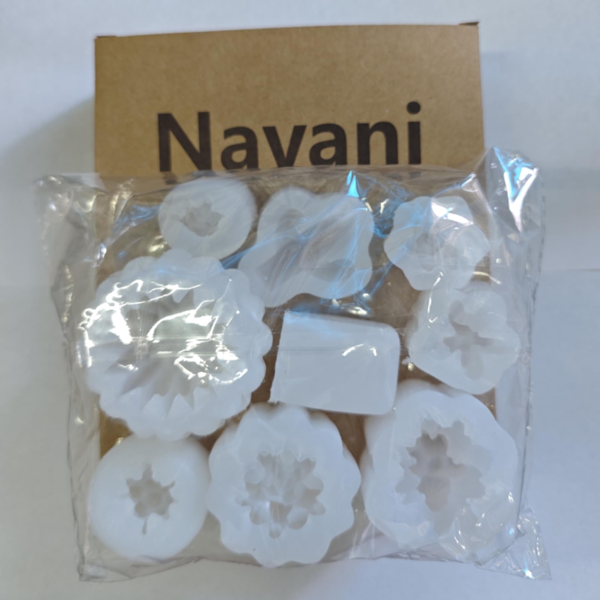 Nine succulent and cactus shaped silicone molds in a clear plastic bag with a cardboard backing.