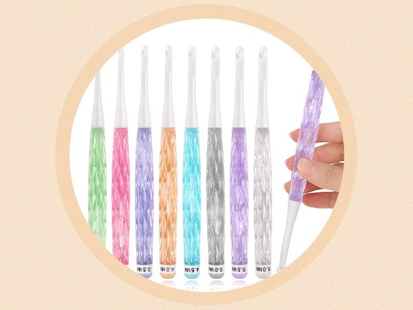 Set of nine ergonomic crochet hooks with colorful faceted grips and white tips, shown in a circular frame.