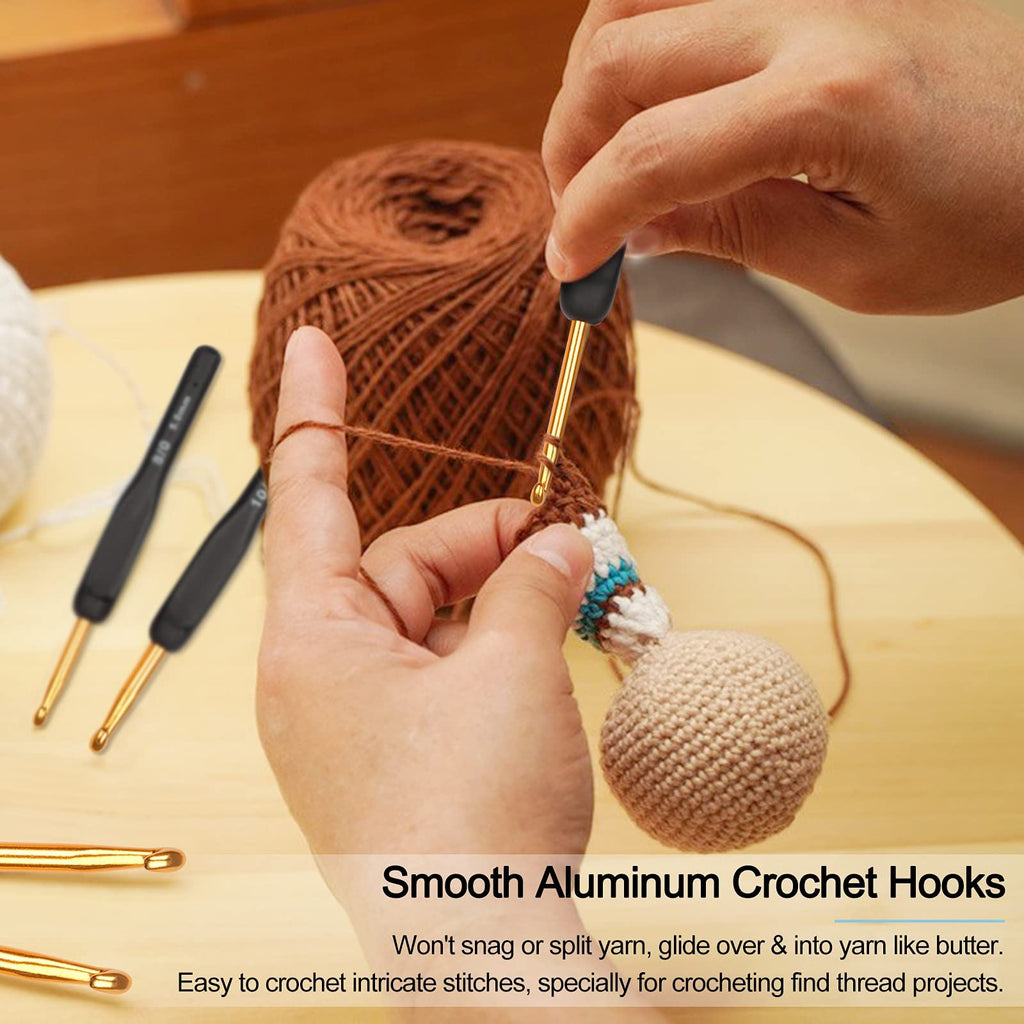 Hands crocheting with aluminum hooks and brown yarn, two hooks visible on left.