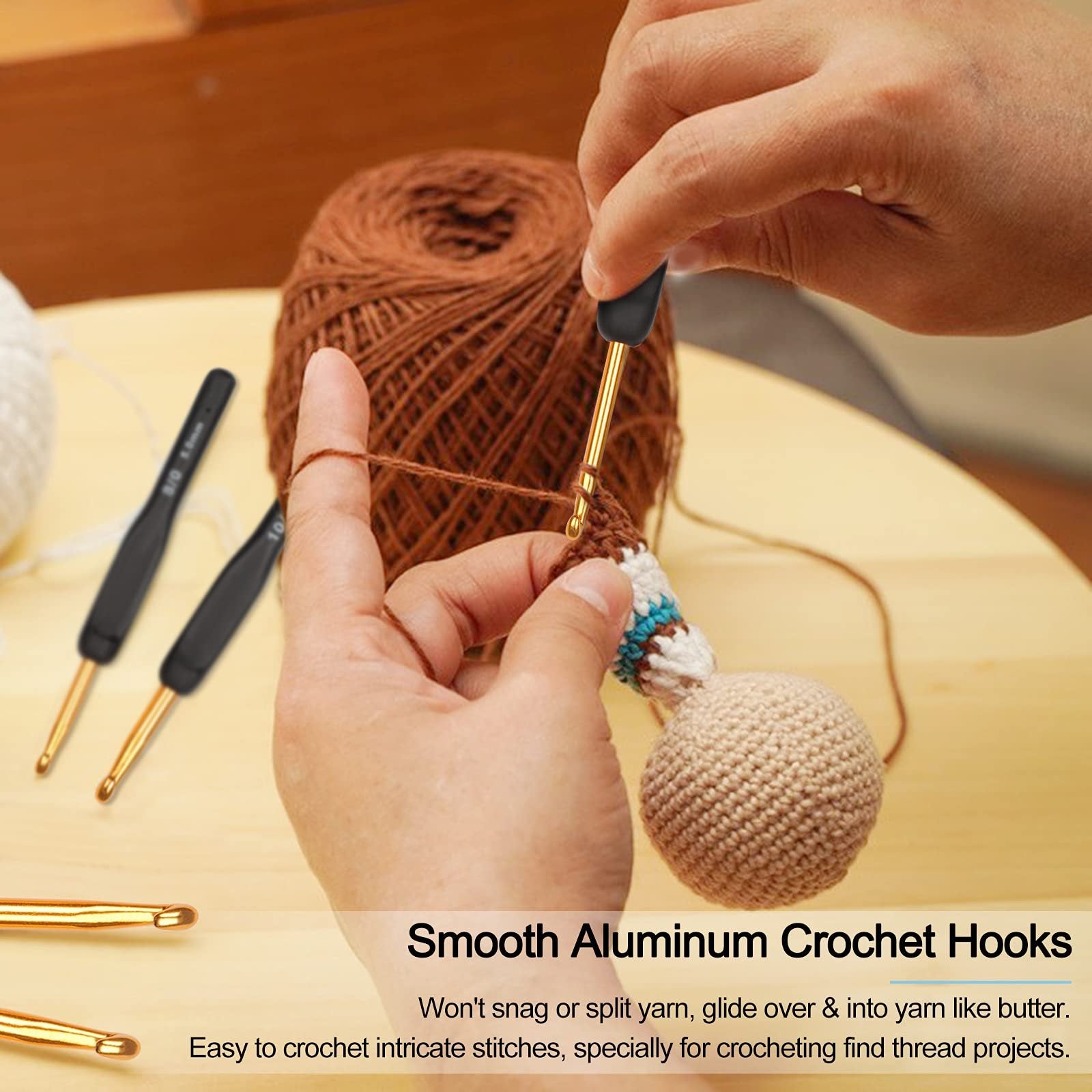 Hands crocheting with aluminum hooks and brown yarn, two hooks visible on left.