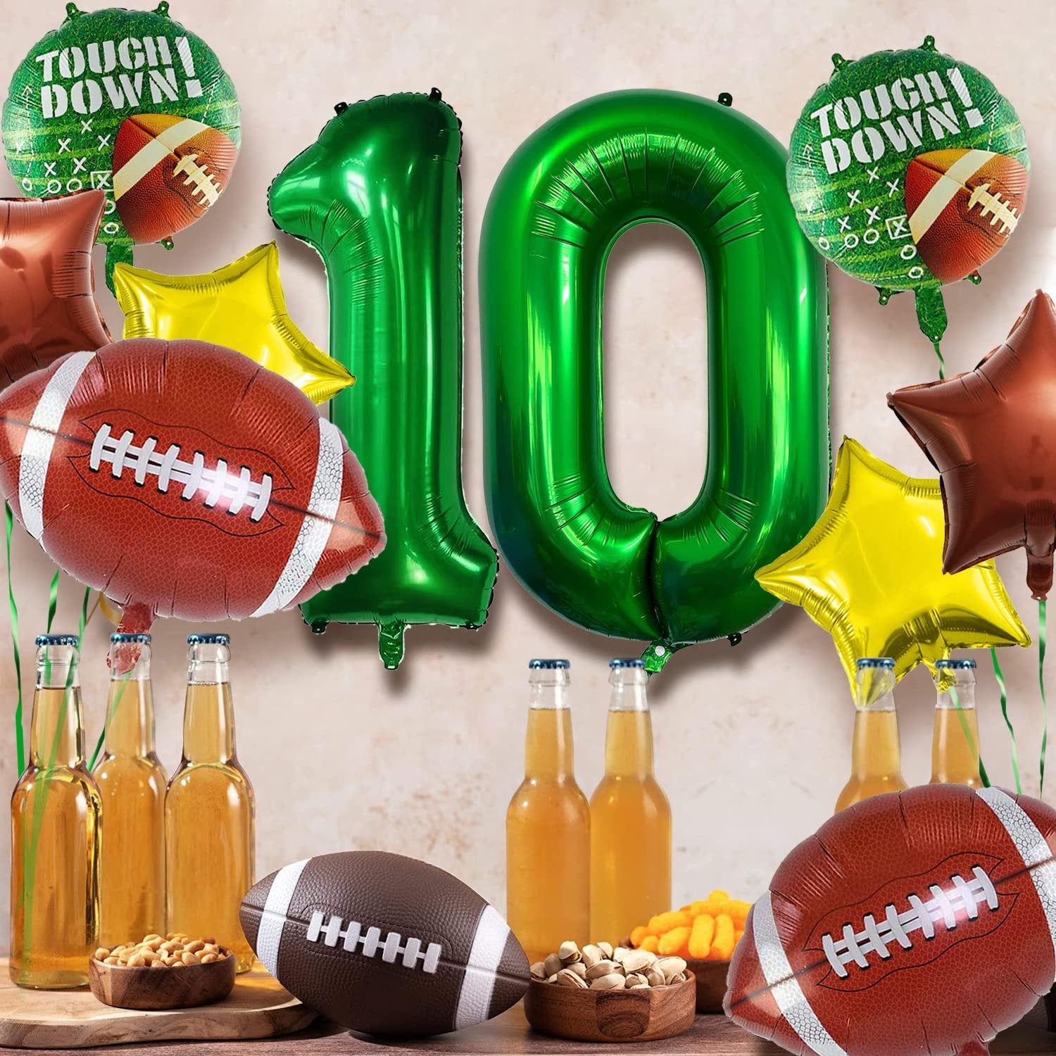 Football themed birthday party balloons including number 10, footballs, stars, and 'Touchdown!' text, with bottles of beer and snacks.