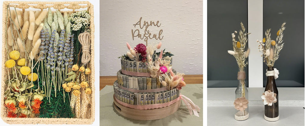 Assortment of dried flowers and grasses in a woven basket, a money cake decorated with dried flowers, and two small dried flower arrangements in bottles.