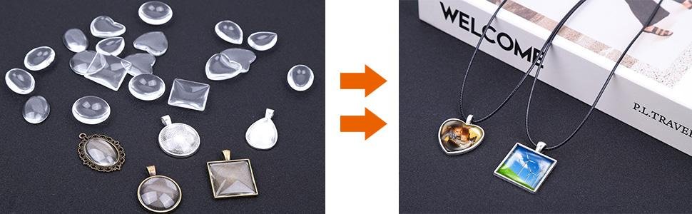 Assortment of clear glass cabochons and metal pendant trays, with two finished necklaces displayed on a book.