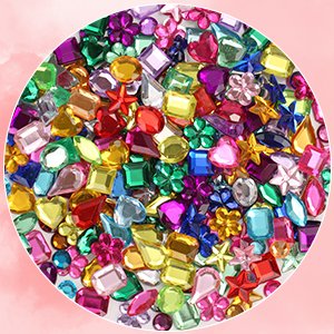 Assorted acrylic flat back craft gems in various shapes and colors, close-up view.