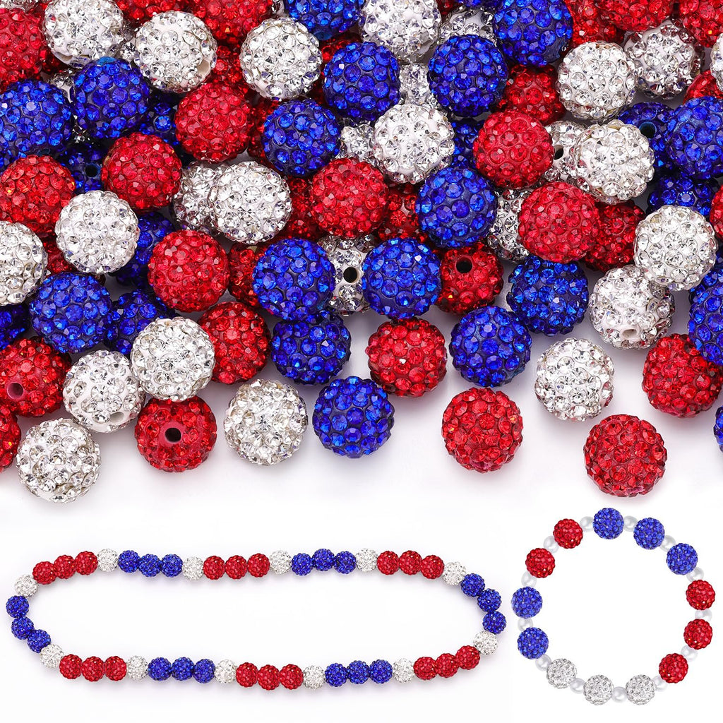 Red, white, and blue rhinestone disco beads scattered and arranged into two bracelets on a white background.