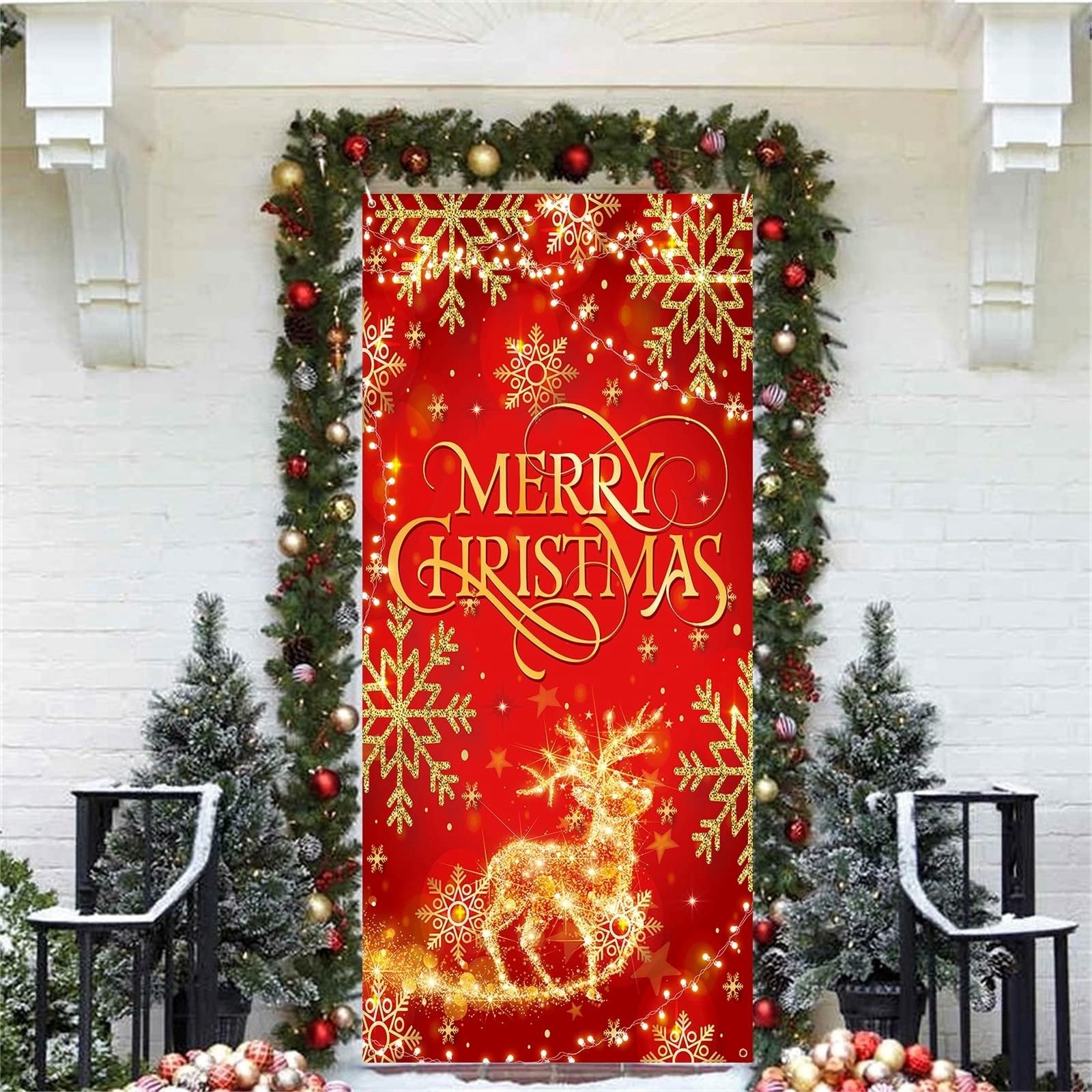 Red glitter fabric Christmas door cover banner with gold snowflakes and a reindeer design, framed by garland and trees.
