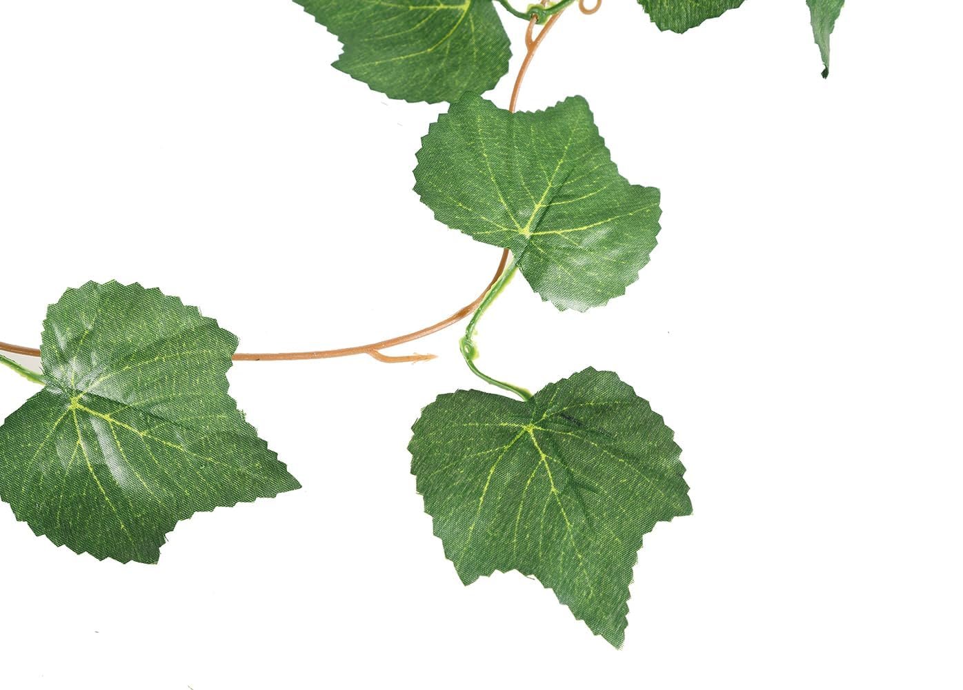 Artificial grape ivy vine garland with green silk leaves and plastic stems on a white background.