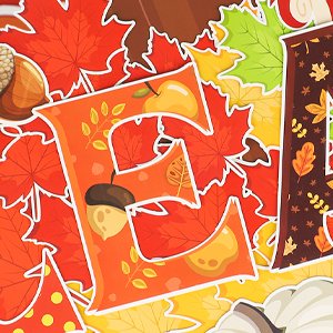 Close-up of fall-themed bulletin board cutouts including letters, maple leaves, acorns, and pumpkins.
