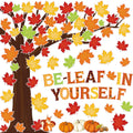 Fall-themed bulletin board set with a tree, maple leaves, pumpkins, acorns, a squirrel, and the words 'BE-LEAF IN YOURSELF'.