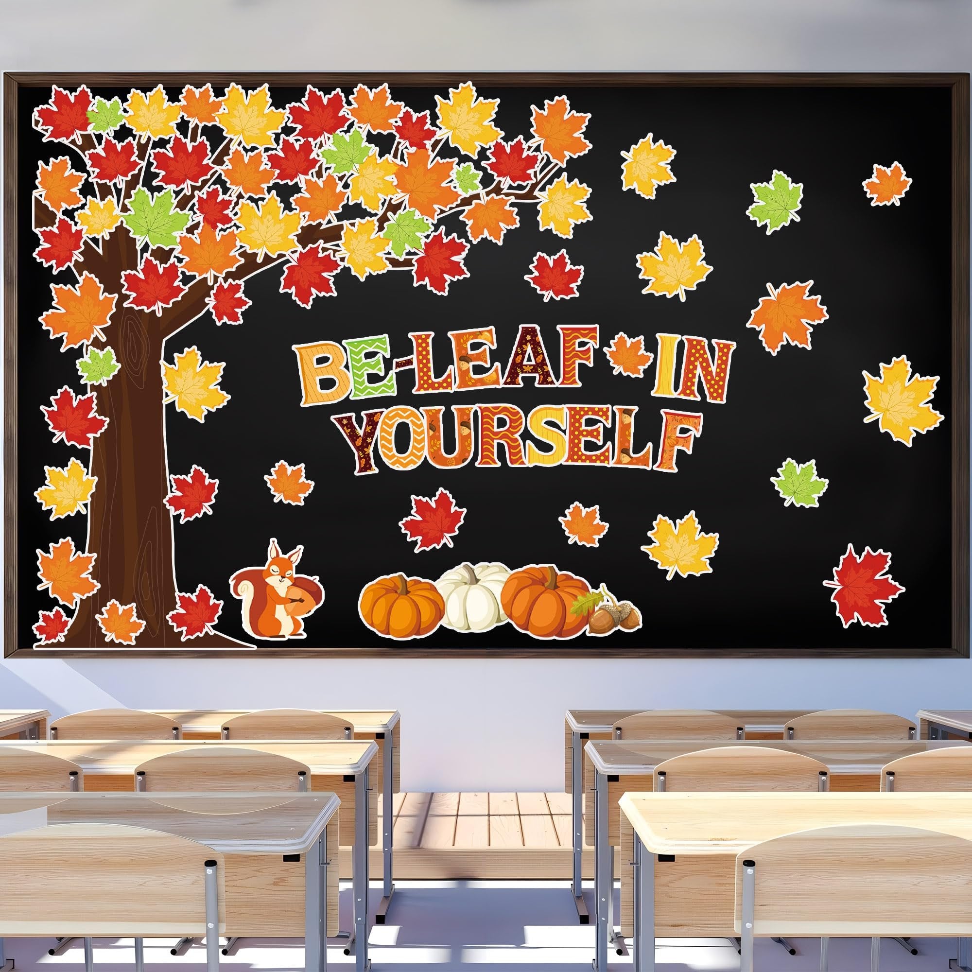 Fall-themed bulletin board cutouts on a chalkboard, featuring a tree with colorful leaves, pumpkins, acorns, a squirrel, and the text "BE-LEAF IN YOURSELF".