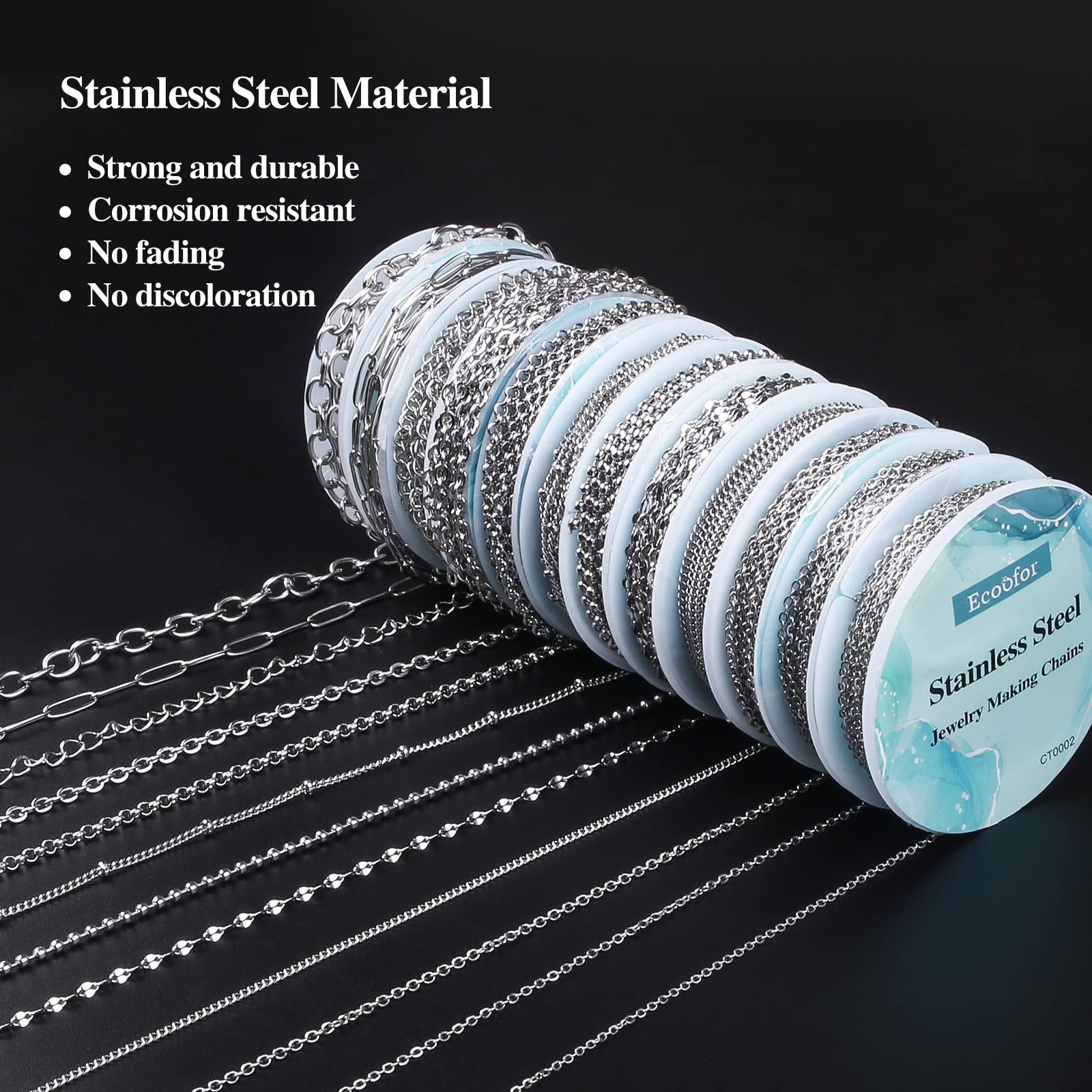 Multiple styles of stainless steel jewelry chains displayed on spools and laid out on a dark surface.