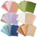 Assortment of textured scrapbook paper and mesh fabric sheets in various colors, fanned out.