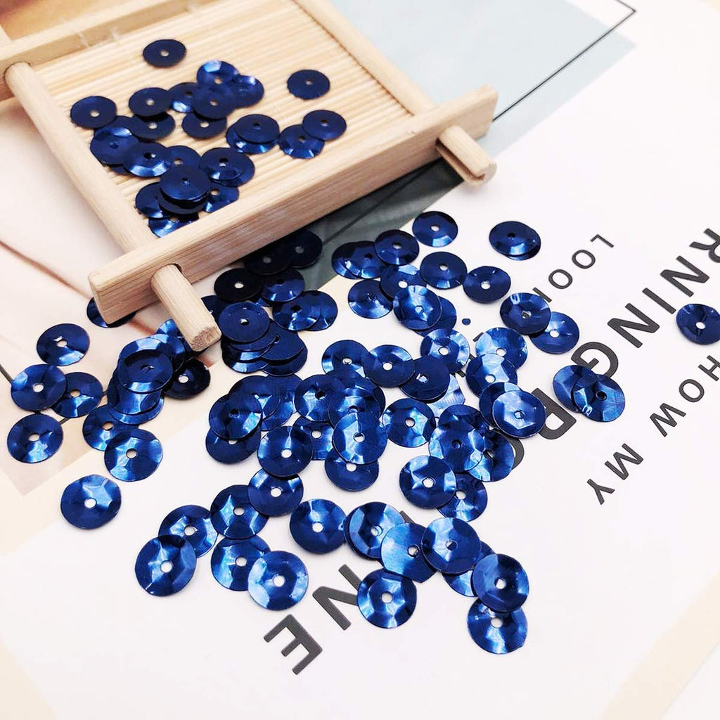 Scattered dark blue 6mm round cup sequins with holes on a white surface with text overlays.