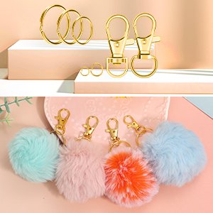 Gold keychains, lobster clasps, jump rings, and fluffy pom-pom keychains in various colors