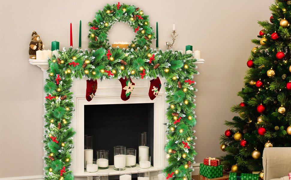 Christmas garland and wreath with LED lights draped over a fireplace, next to a decorated Christmas tree.